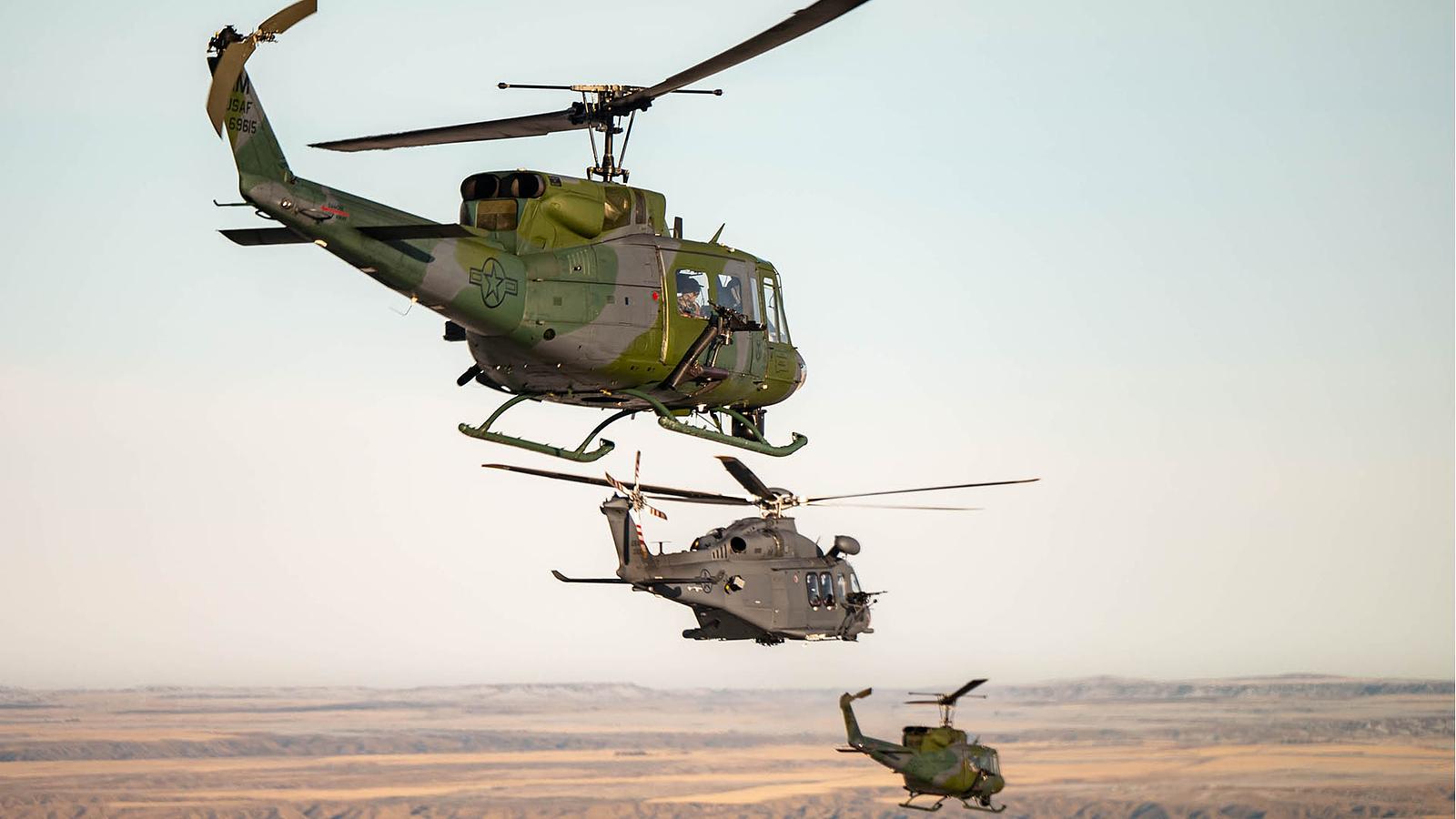 An MH-139A (center) joins two UH1N-Hueys on a simulated mission during the start of Initial Operational Test and Evaluation (IOT&E) testing