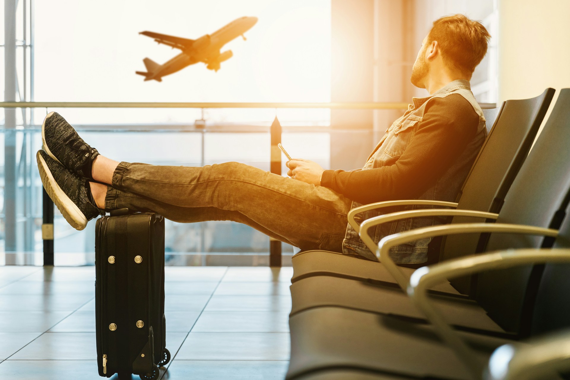 TravelMan SummerSunset Boy Plane Holiday Adventure Vacation Mobile Aircraft Travelling Suitcase Luggage Air Wait Abroad Takeoff Feet Up Looking Away Public Domain Images