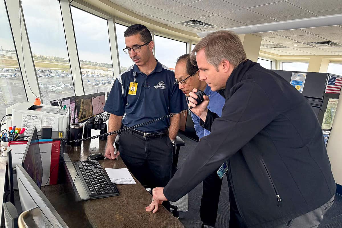 Embry-Riddle researchers Dr. Jianhua Liu and Andrew Schneider are collaborating on a project that uses artificial intelligence to improve the clarity and safety of radio communications between pilots and air traffic controllers. Here, they are pictured with lead flight supervisor Chris Deputy (left) in the Flight Supervisor Tower. (Photo: Embry-Riddle/Melanie Stawicki Azam)